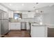 Renovated kitchen with stainless steel appliances, granite countertops, and white cabinets enhancing its sleek appearance at 2844 W Christy Dr, Phoenix, AZ 85029