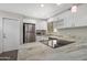 Well-lit kitchen featuring stainless steel appliances, granite counters, white cabinets, and an electric cooktop on the island at 2844 W Christy Dr, Phoenix, AZ 85029