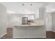 Bright kitchen boasts white cabinets, stainless steel refrigerator, and a center island with a cooktop at 2844 W Christy Dr, Phoenix, AZ 85029