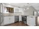 Updated kitchen featuring stainless steel appliances, granite countertops, and sleek white cabinets for a modern look at 2844 W Christy Dr, Phoenix, AZ 85029