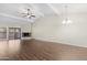 Bright, expansive living room with wood flooring, stone fireplace, and sliding glass doors, ideal for relaxation and entertaining at 2844 W Christy Dr, Phoenix, AZ 85029