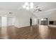 Open living area with vaulted ceilings, hardwood floors, fireplace, and sliding doors to outdoor space, offering seamless flow at 2844 W Christy Dr, Phoenix, AZ 85029