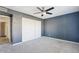 Spacious bedroom with gray walls, carpeted floor, and a closet with sliding doors at 2916 E Amber Ridge Way, Phoenix, AZ 85048