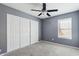 Bedroom with a ceiling fan, window with blinds, and closet with sliding doors at 2916 E Amber Ridge Way, Phoenix, AZ 85048