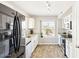 Clean kitchen with stainless steel appliances, granite counters, and white cabinetry at 2916 E Amber Ridge Way, Phoenix, AZ 85048