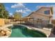 The private pool has a rock waterfall and cool decking at 2916 E Amber Ridge Way, Phoenix, AZ 85048