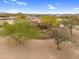 Aerial view of the property showing the home, perimeter wall, and surrounding desert landscape at 29204 N Bryce Trl, Queen Creek, AZ 85144