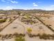 Expansive aerial view showcasing the desert property, horse facilities and surrounding landscape under a blue sky at 29204 N Bryce Trl, Queen Creek, AZ 85144