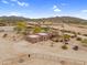 Aerial view of a Southwestern-style home with desert landscaping, horse property and mountain views at 29204 N Bryce Trl, Queen Creek, AZ 85144