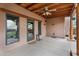 Back patio includes wood beam ceiling, ceiling fan, windows and door leading inside at 29204 N Bryce Trl, Queen Creek, AZ 85144