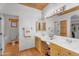 Bright bathroom featuring double sinks, wooden cabinets, and rustic accents and tile flooring at 29204 N Bryce Trl, Queen Creek, AZ 85144