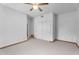 Bedroom featuring carpet floors, a ceiling fan, closet with sliding doors, and wooden door at 29204 N Bryce Trl, Queen Creek, AZ 85144