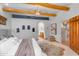 Primary bedroom features exposed beams, niches, and access to ensuite bathroom at 29204 N Bryce Trl, Queen Creek, AZ 85144