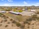 The equestrian facility features horse stalls, a riding area and a large storage structure with views of the desert landscape at 29204 N Bryce Trl, Queen Creek, AZ 85144