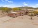 A Southwestern style home features a flat roof, stucco exterior, desert landscaping and mountain views at 29204 N Bryce Trl, Queen Creek, AZ 85144