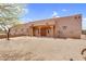 Home featuring a desert landscape, a flat roof, a stucco exterior and a covered front entrance at 29204 N Bryce Trl, Queen Creek, AZ 85144