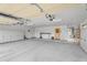 Spacious garage with ample storage cabinets, overhead door and opener, and work table at 29204 N Bryce Trl, Queen Creek, AZ 85144