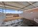 Inside a covered horse stall showing wood framing, dirt floor, steel beams, and a rear exit at 29204 N Bryce Trl, Queen Creek, AZ 85144