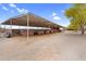 Open horse stalls with a metal roof, wood framing, and dirt floor, providing ample space for equine residents at 29204 N Bryce Trl, Queen Creek, AZ 85144