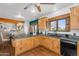 Kitchen featuring rustic wood cabinets, tile counters, and terracotta flooring at 29204 N Bryce Trl, Queen Creek, AZ 85144