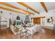 Inviting living room with beamed ceilings, a fireplace, and Saltillo tile floors at 29204 N Bryce Trl, Queen Creek, AZ 85144