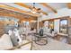 Spacious living room with a cozy fireplace, wood beam ceilings, and comfortable seating arrangements at 29204 N Bryce Trl, Queen Creek, AZ 85144