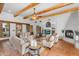 Bright living room featuring beamed ceilings, fireplace, Saltillo tile floors and comfortable seating at 29204 N Bryce Trl, Queen Creek, AZ 85144