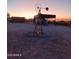 Charming windmill decoration against a colorful sunset background on the property at 29204 N Bryce Trl, Queen Creek, AZ 85144