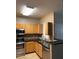 Well-lit kitchen boasting stainless steel appliances, granite countertops, and sleek fixtures for a stylish cooking experience at 2929 W Yorkshire Dr # 2118, Phoenix, AZ 85027