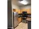 Bright kitchen featuring stainless steel appliances, granite counters, light wood cabinets, and modern lighting at 2929 W Yorkshire Dr # 2118, Phoenix, AZ 85027