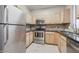 Kitchen with stainless steel appliances, granite countertops, and light wood cabinets provides a modern cooking space at 2929 W Yorkshire Dr # 2118, Phoenix, AZ 85027