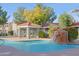 Community pool with gazebo, rock waterfall feature, and colorful landscaping at 2929 W Yorkshire Dr # 2118, Phoenix, AZ 85027