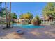 Community pool area features a gazebo, a rock waterfall feature, a fire pit, and ample lounge seating at 2929 W Yorkshire Dr # 2118, Phoenix, AZ 85027