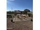 Backyard setup with chairs and desert landscaping, creating a comfortable outdoor living area for gatherings at 29908 W Monterey Dr, Buckeye, AZ 85396