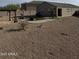 Large backyard with gravel landscaping, a pergola, and green grass, offering a versatile outdoor living space at 29908 W Monterey Dr, Buckeye, AZ 85396