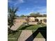 A spacious backyard featuring a pergola, artificial grass, and gravel landscaping, perfect for outdoor entertaining at 29908 W Monterey Dr, Buckeye, AZ 85396