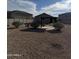 A well-maintained backyard with desert landscaping, a pergola, and views of neighboring houses, offering a serene setting at 29908 W Monterey Dr, Buckeye, AZ 85396