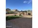 Desert landscaped backyard with pergola and gravel, offering a low-maintenance outdoor space for enjoyment at 29908 W Monterey Dr, Buckeye, AZ 85396