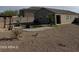 Spacious desert backyard featuring gravel landscaping, a pergola, and a patch of green grass, perfect for outdoor activities at 29908 W Monterey Dr, Buckeye, AZ 85396