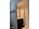 Bathroom with tile flooring, dark cabinets, and a wood framed mirror at 29908 W Monterey Dr, Buckeye, AZ 85396