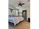Bedroom features soft carpet, ceiling fan, and a bathroom door at 29908 W Monterey Dr, Buckeye, AZ 85396