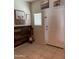 Inviting entryway featuring stylish decor, a white door, and tiled flooring at 29908 W Monterey Dr, Buckeye, AZ 85396