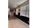 Long hallway features tiled floors, white blinds, and decor at 29908 W Monterey Dr, Buckeye, AZ 85396