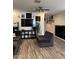 Open concept living room features a flat screen TV, modern decor, and wood flooring at 29908 W Monterey Dr, Buckeye, AZ 85396