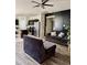 Open-concept living room with stylish furniture and adjacent kitchen, perfect for entertaining at 29908 W Monterey Dr, Buckeye, AZ 85396
