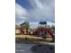 Playground features multiple slides, climbing structures, and spring riders, offering a variety of activities at 29908 W Monterey Dr, Buckeye, AZ 85396