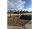 Swings in playground is ready for fun, set against a backdrop of trees and a bright sky in Tartesso Community Park at 29908 W Monterey Dr, Buckeye, AZ 85396