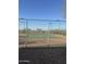 Outdoor tennis court enclosed with a chainlink fence for recreational enjoyment at 29908 W Monterey Dr, Buckeye, AZ 85396