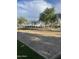 Well-maintained sand volleyball court with mature landscaping around it at 29908 W Monterey Dr, Buckeye, AZ 85396