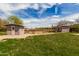 The backyard contains sheds, offering practical space for storage or hobbies at 3137 W Baseline Rd, Laveen, AZ 85339